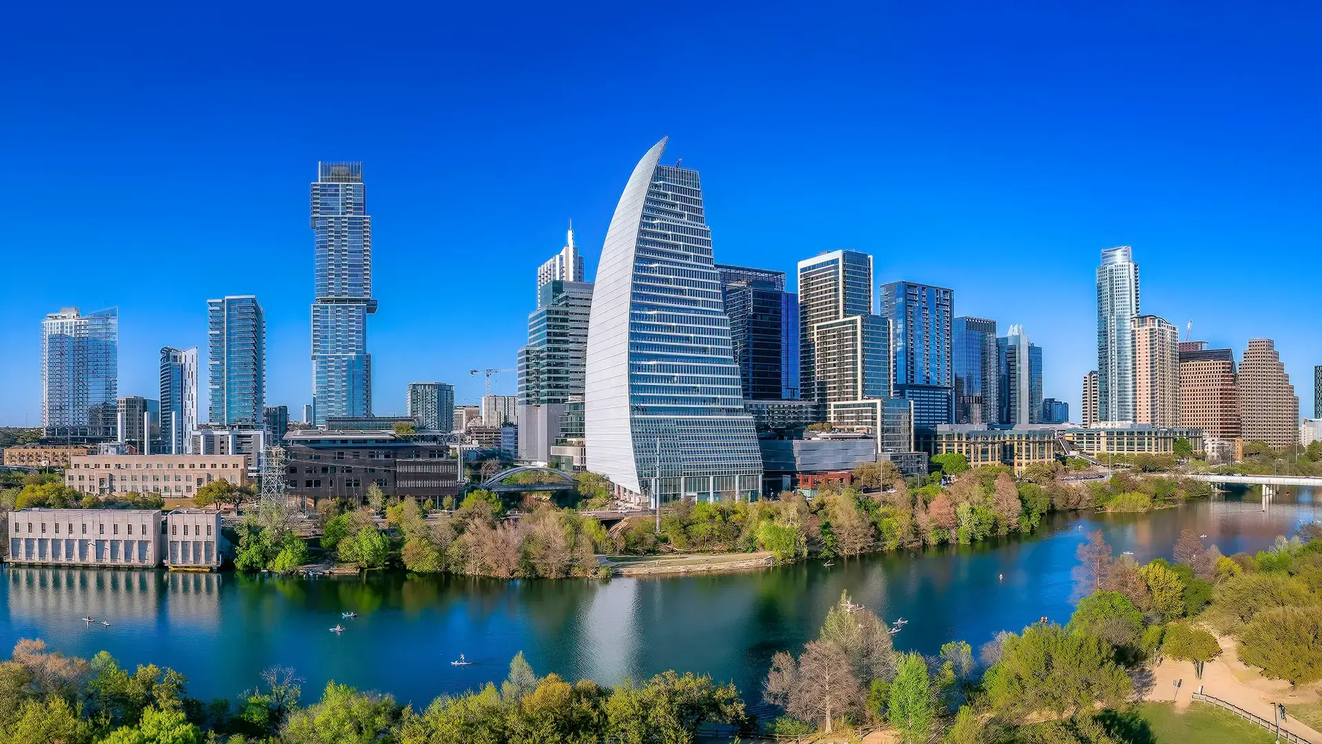 anoramic view of the Austin, Texas skyline and Lady Bird Lake, representing the headquarters and local roots of Fortitude Advisors investment bank.