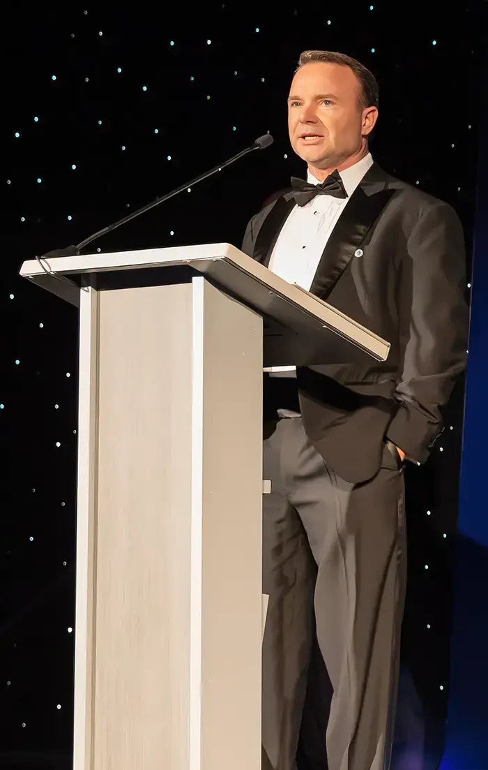 CEO of Fortitude Advisors, Sean Kelly, speaks at a gala.